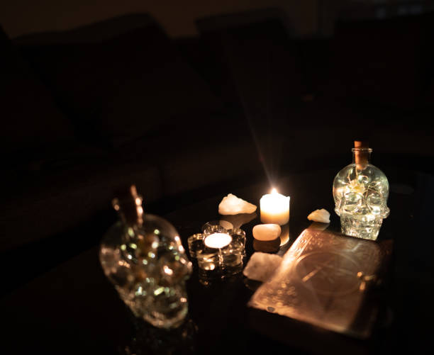 istock Decoration with esoteric book surrounded by glass Skull 1306157326