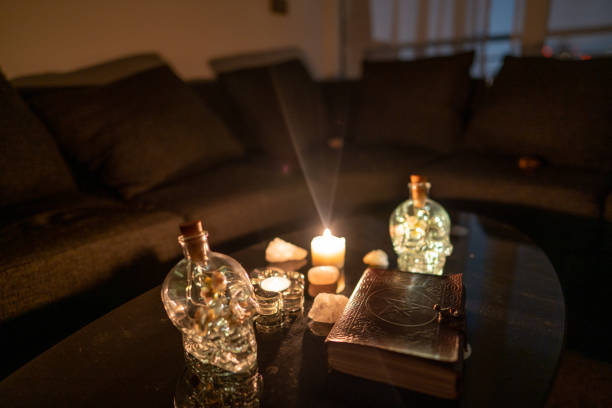 istock Decoration with esoteric book surrounded by glass Skull 1306157351
