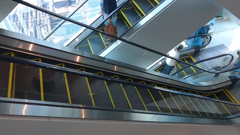 Footage of People on Escalator Staircase in Modern Building