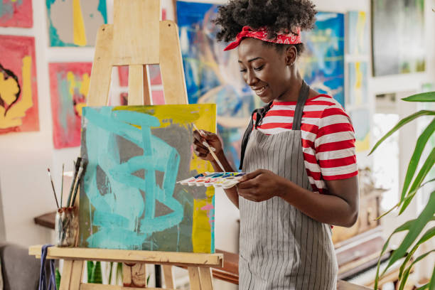 istock A young female artist expresses her creativity through painting 1306159904