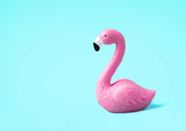 istock Pink toy flamingo on a light blue background 1306159914