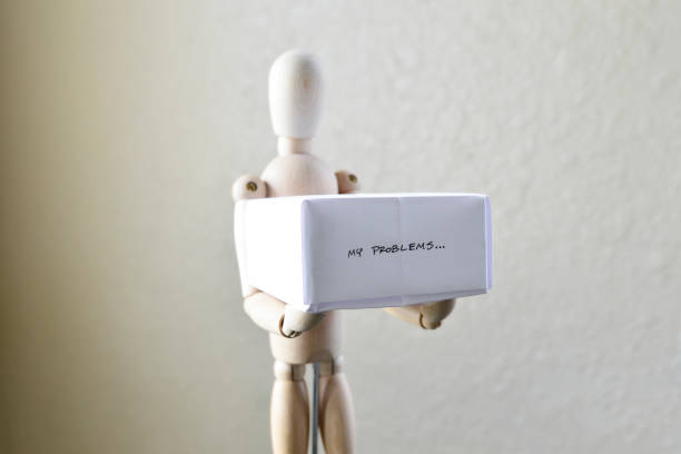 istock Wooden Figure Holding “My Problems” Box 1306160481