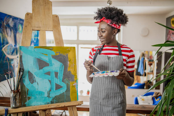 istock A young female artist expresses her creativity through painting 1306160539