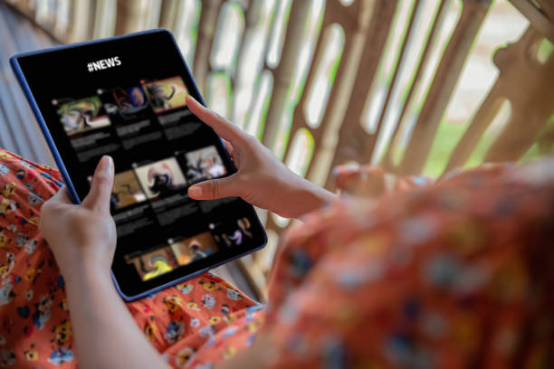 Asian Woman Reading News on Digital Tablet