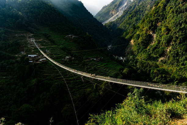 New Bridge: the longest suspension bridge in Himalaya mountain range in Nepal Picture of New Bridge: the longest suspension bridge in Himalaya mountain range in Nepal annapurna circuit photos stock pictures, royalty-free photos & images