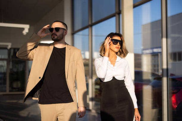 istock Two well dressed colleagues leaving office building 1306165285
