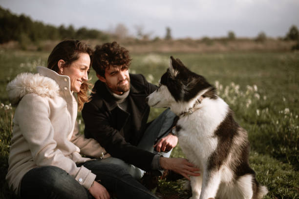 istock Couple playing with their dog 1306169518