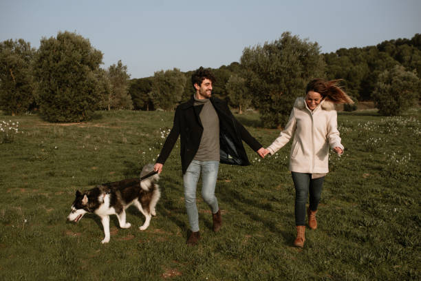 istock Young couple walking their dog 1306169637