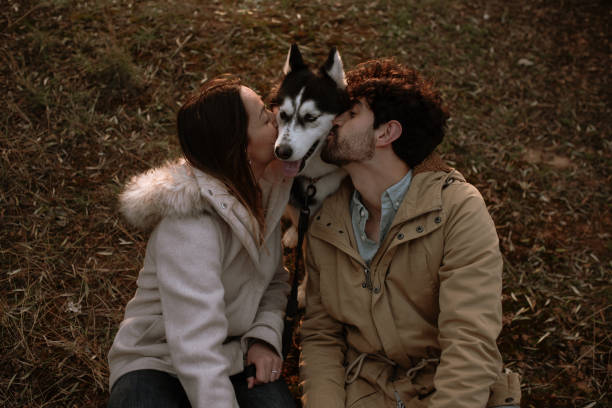 istock Young couple kissing their dog 1306170076