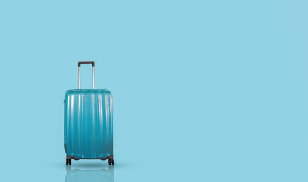 istock Blue stylish travel suitcase isolated on blue background. 1306171282