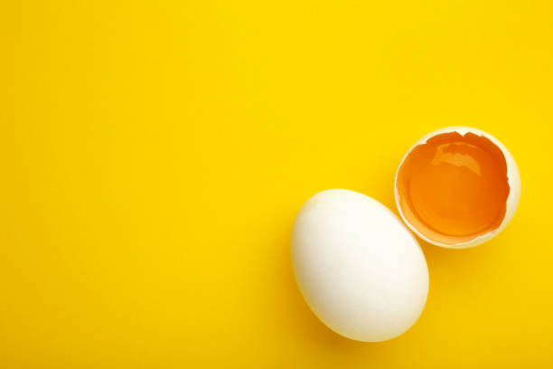 istock Easter decoration white eggs on yellow background, minimal design with space for text 1306175185