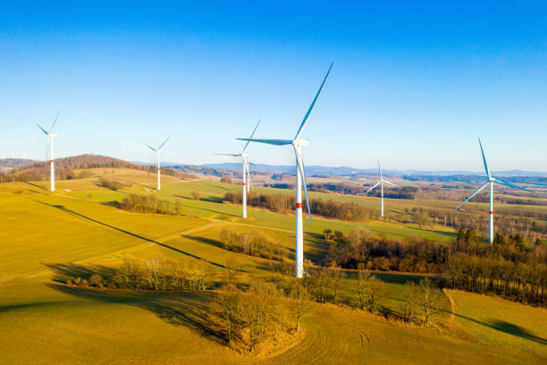Panoramic view of wind farm or wind park, with high wind turbines for generation electricity with copy space. Green energy concept. Panoramic view of wind farm or wind park, with high wind turbines for generation electricity with copy space. Green energy concept landscape alternative energy scenics farm stock pictures, royalty-free photos & images