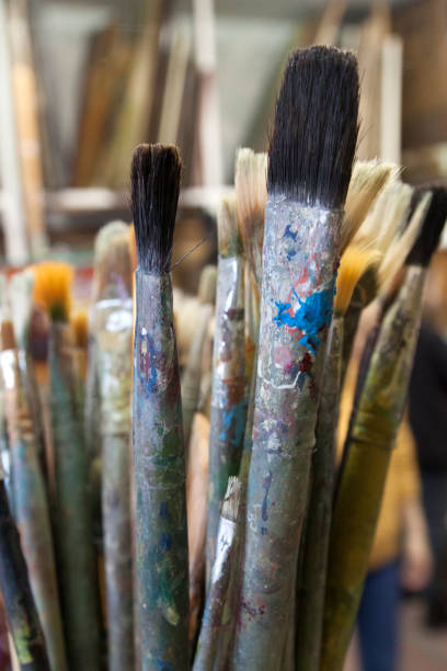 istock Used bristle old art brushes in paint residues. 1306176077