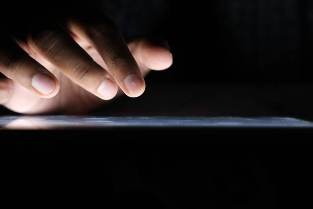 istock Close up of hacker hand stealing data from digital tablet 1306176659
