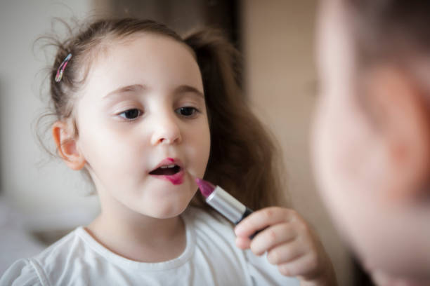istock Little girl's first lipstick 1306179749