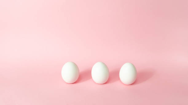 istock Three white chicken eggs isolated on light pink pastel background. Happy Easter Day. Greeting card. 1306180058