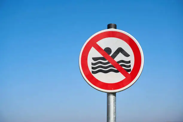 Signs erected at the end of the bathing season in Germany stating that bathing is prohibited. The signs are removed at the beginning of the bathing season.