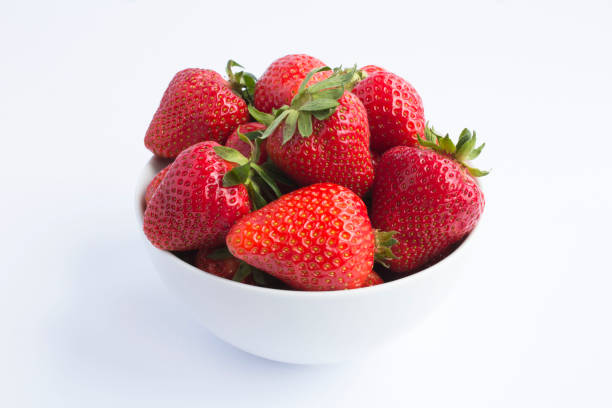 istock Strawberry in the white bowl on the white background 1306181292
