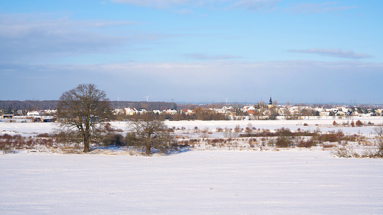 View of the banks of the Elbe with the Elbe meadows in winter. In the background the village Glindenberg.
