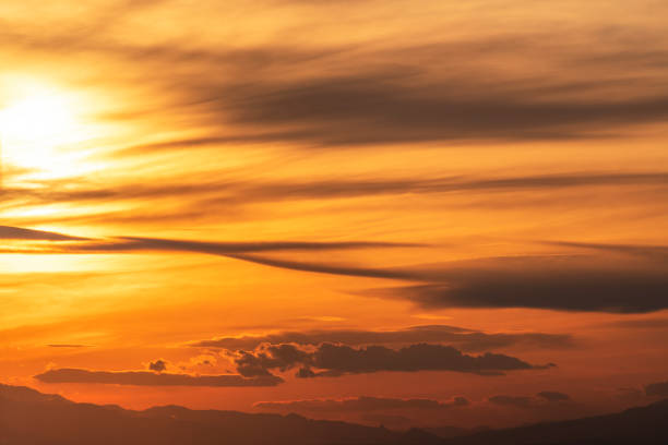 Beautiful dark orange sky with clouds after sunset. Nature sky sunset background.