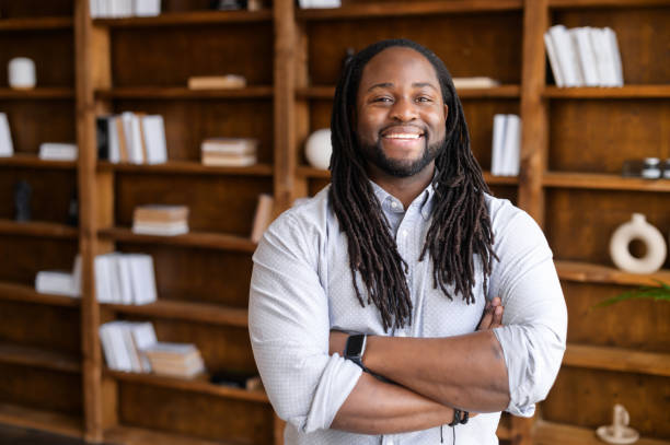 istock A cheerful African-American guy with arms crossed 1306183967