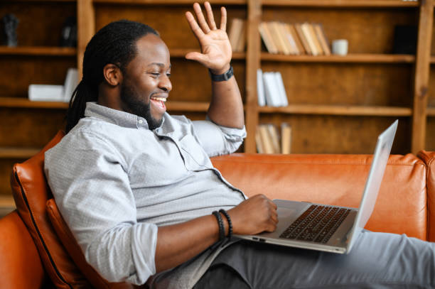istock An African-American guy using a laptop for video call 1306184058
