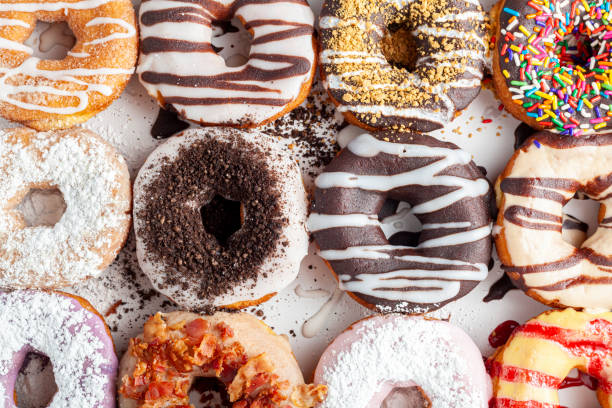istock Flat lay top view image of a dozen donuts on card board box 1306184275