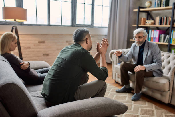 istock Depressed caucasian man talking to psychotherapist 1306185716