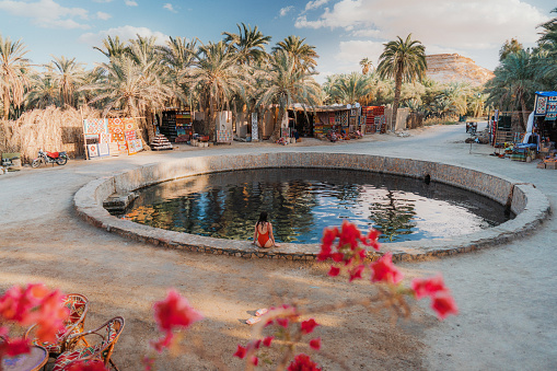 Woman swimming in Cleopatra spring in Siwa oasis