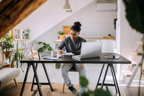 istock Student studying from the comfort of his home 1306186325