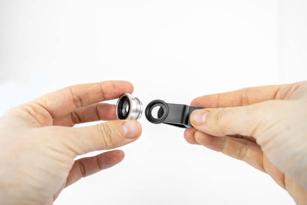 Phone photo lens with clips on white background. Extra macro camera for smartphone