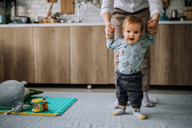 istock Cute little baby boy making his first steps 1306186794