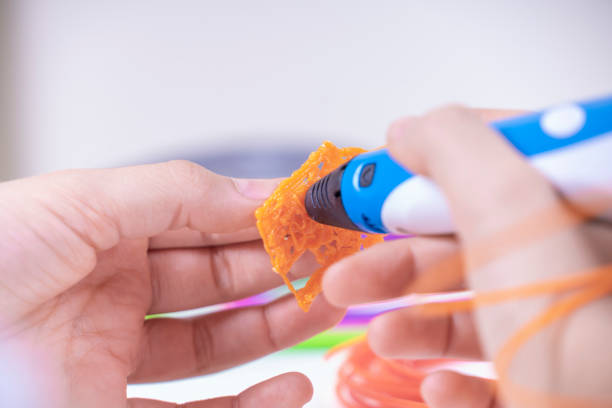 istock Child hands creating new 3d object with 3d pen. Learning and entertainment at home. Top view 1306188423