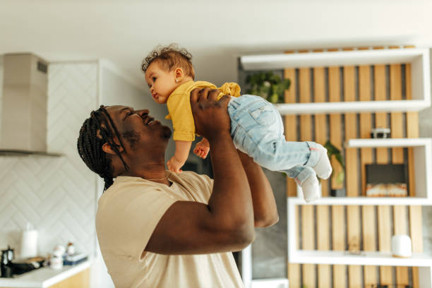 istock Dad holding his baby girl, smiling face. 1306189280