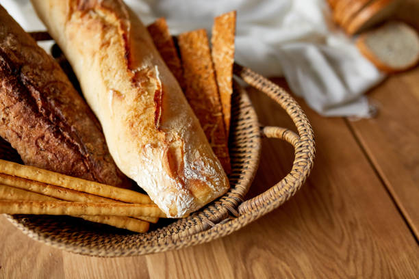 istock Top view of various kinds of bread on a wooden surface. 1306189617