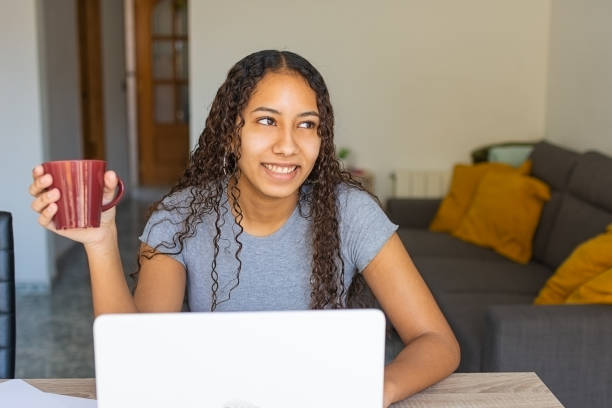 istock young girl smiling with a cup of coffee 1306190625