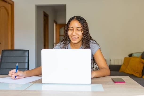 istock young woman smiling at the computer camera. 1306190767