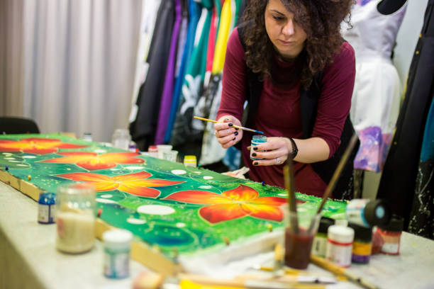 istock Woman painting in a batik workshop 1306191774