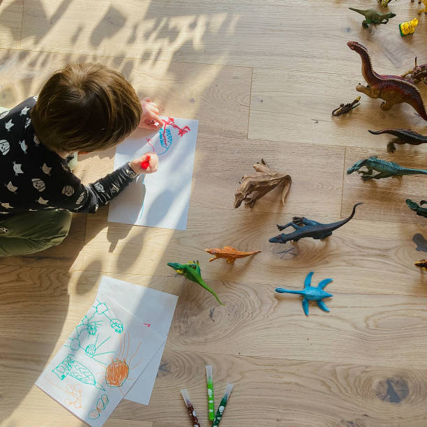 istock Kid drawing on the floor 1306191970