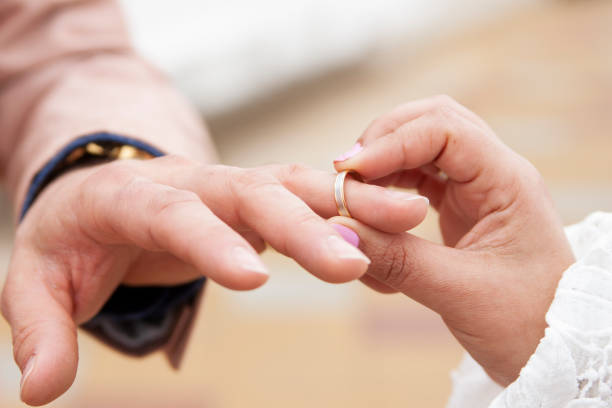 istock Women's hands placing the marriage alliance on a man 1306193494