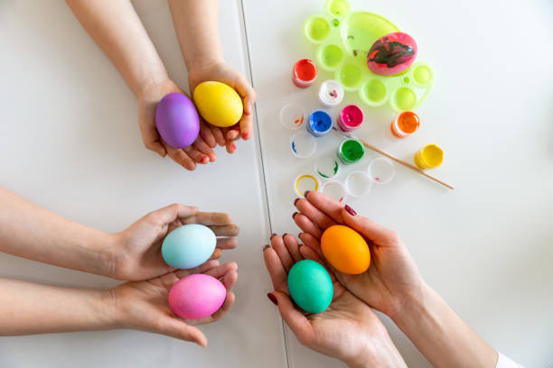 istock Hands of family members are holding many painted Easter eggs. Easter decoration concept 1306193765