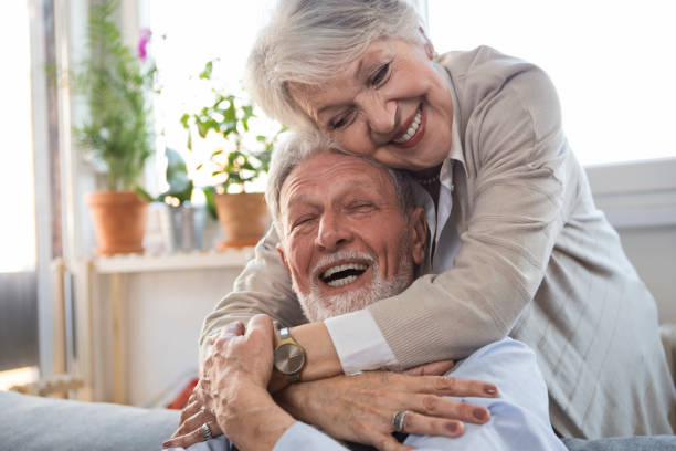 istock Woman embracing husband sitting on the sofa looking at each other 1306195679