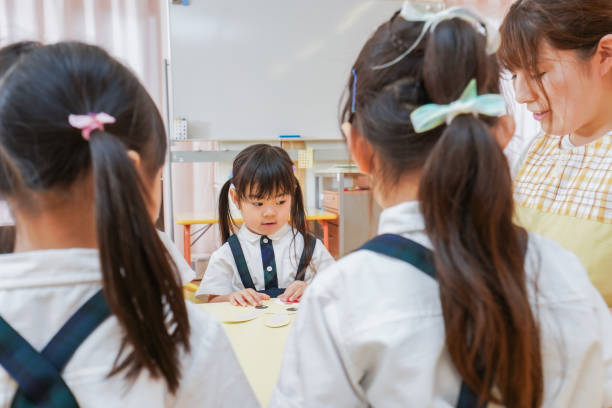 istock Children and teacher at nursery school 1306196097