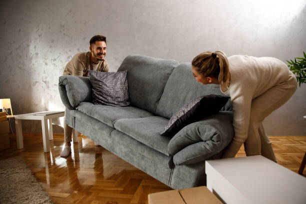 istock Couple moving the sofa  in their new apartment 1306196245