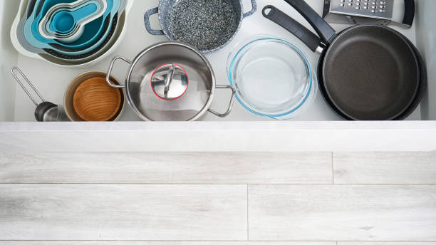 istock Set of clean kitchenware and utensils in drawers, space for text. Above view. 1306196786