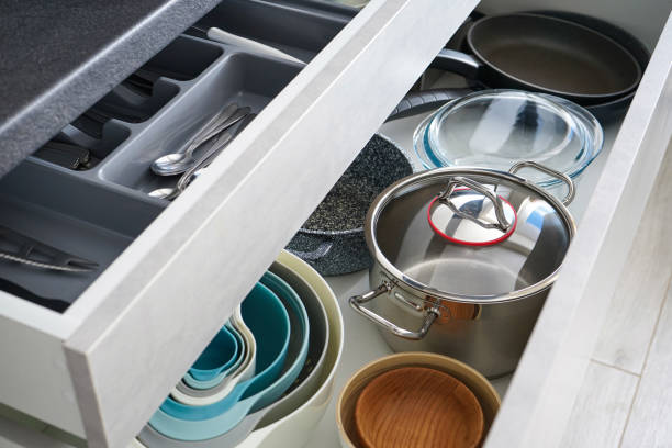 istock Set of clean kitchenware and utensils in drawers, flat lay. 1306196794