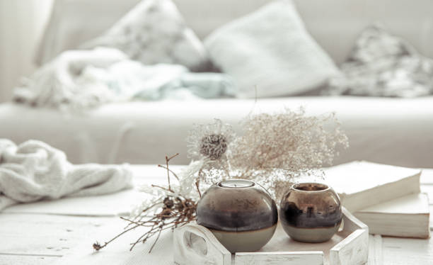 istock Scandinavian home arrangement with candlesticks, dry twigs and a book. 1306198559