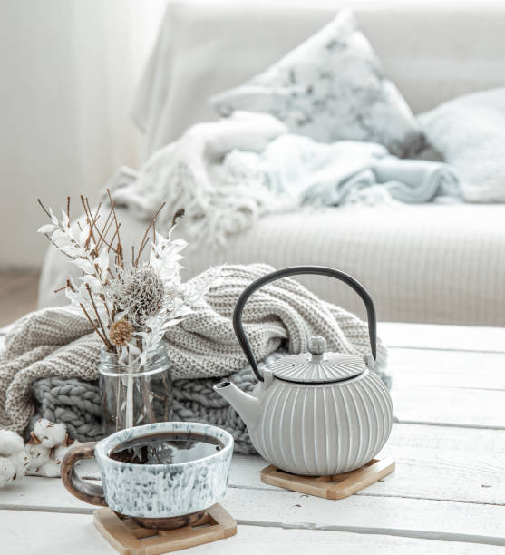istock Cozy Scandinavian composition with teapot, ceramic cup of tea and decor details. 1306198564