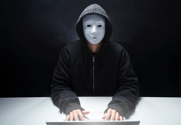 istock anonymous hacker with hood and mask spreading viruses 1306198800