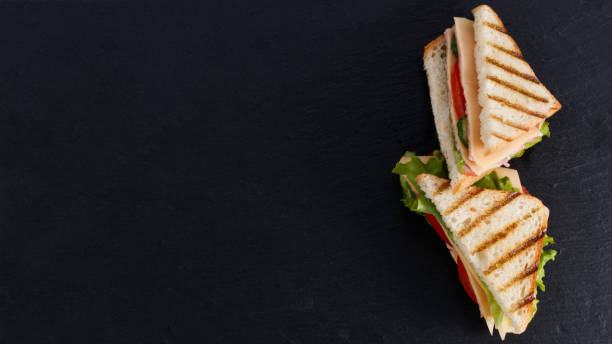 istock sandwich with ham and lettuce and cheese on a dark background with copy space 1306201036